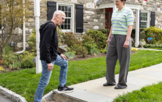 Person outside their home checking the step on their sidewalk