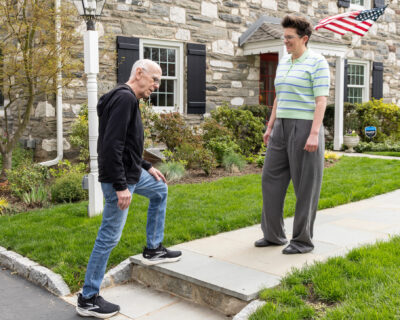 Person outside their home checking the step on their sidewalk