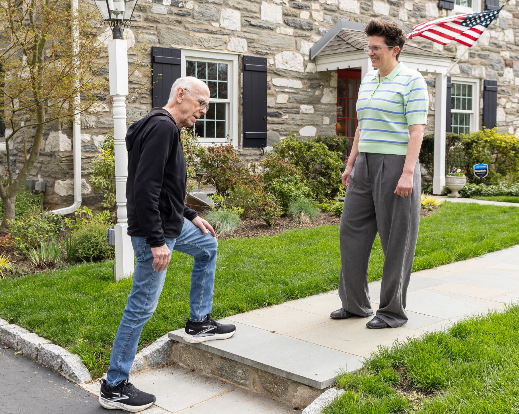 Person outside their home checking the step on their sidewalk